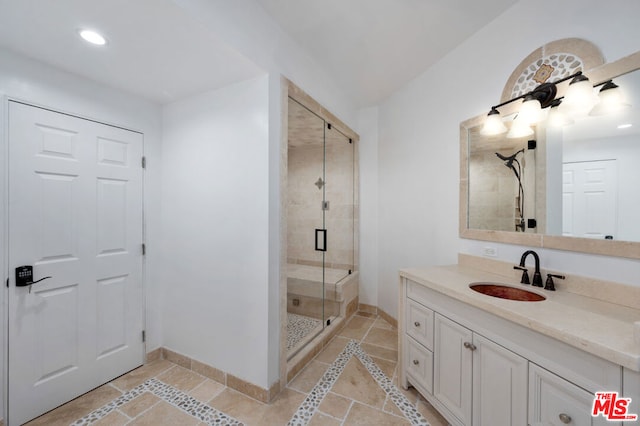 bathroom featuring vanity and a shower with shower door