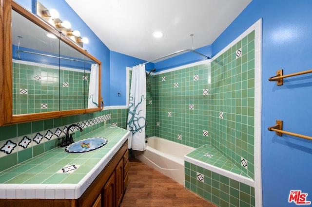 bathroom featuring vanity, hardwood / wood-style floors, and shower / bath combo with shower curtain