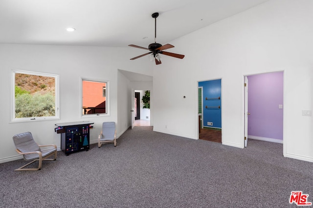 unfurnished bedroom featuring ceiling fan, high vaulted ceiling, and dark carpet