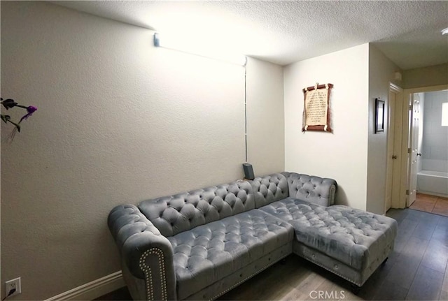 living area featuring hardwood / wood-style floors and a textured ceiling