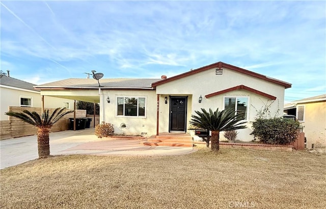 view of front of property with a front lawn and a carport