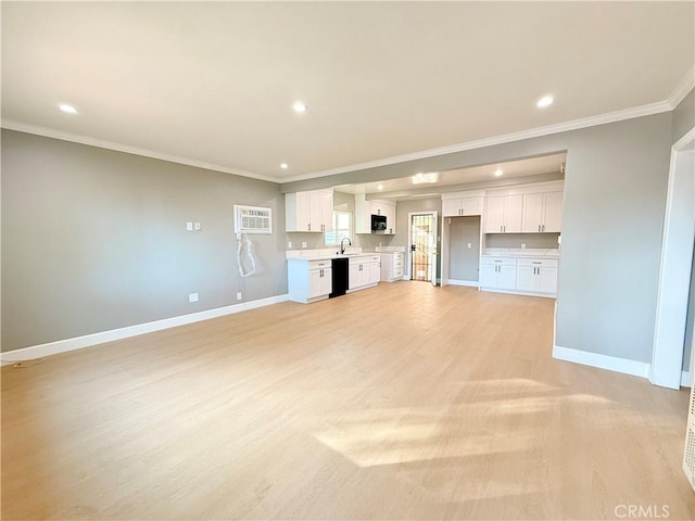 unfurnished living room with crown molding and light hardwood / wood-style floors