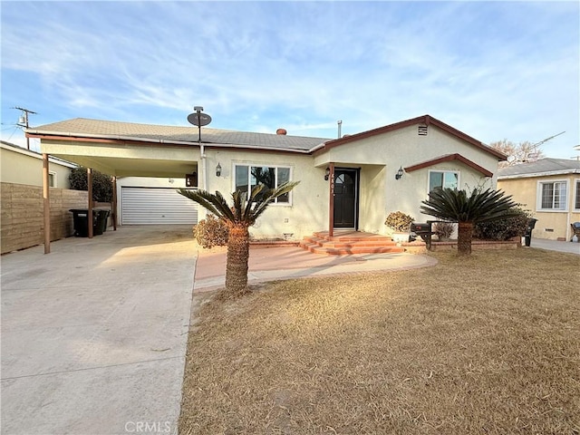 view of front of home with a carport and a garage