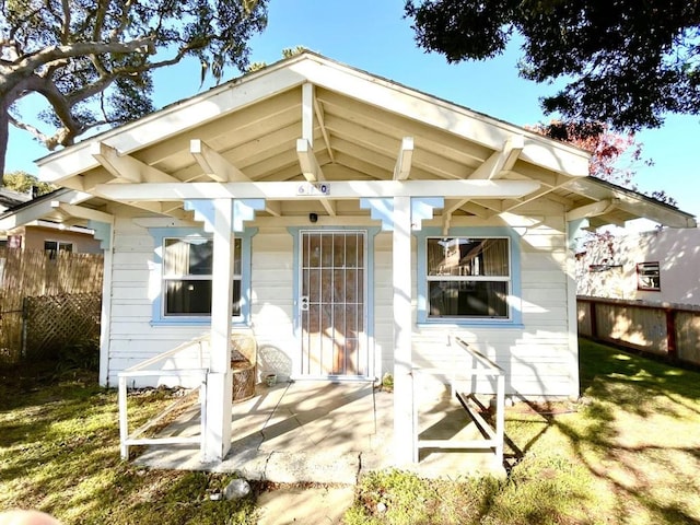 back of house with a lawn