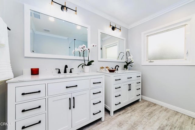 bathroom with vanity, crown molding, and hardwood / wood-style flooring