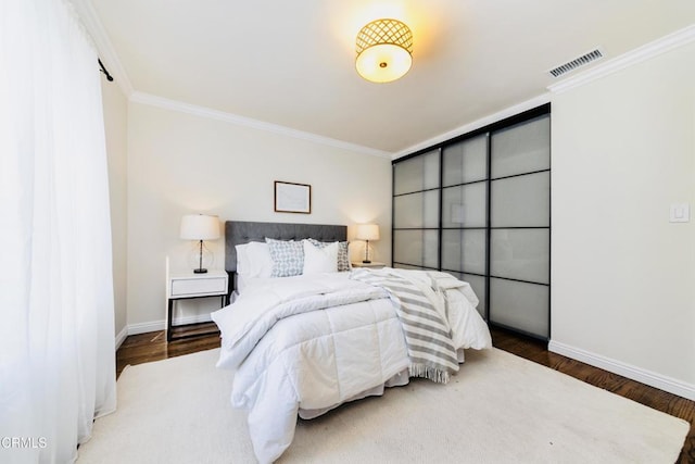 bedroom with wood-type flooring and ornamental molding