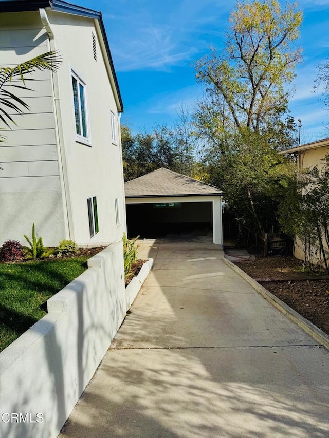 view of property exterior with an outbuilding and a garage