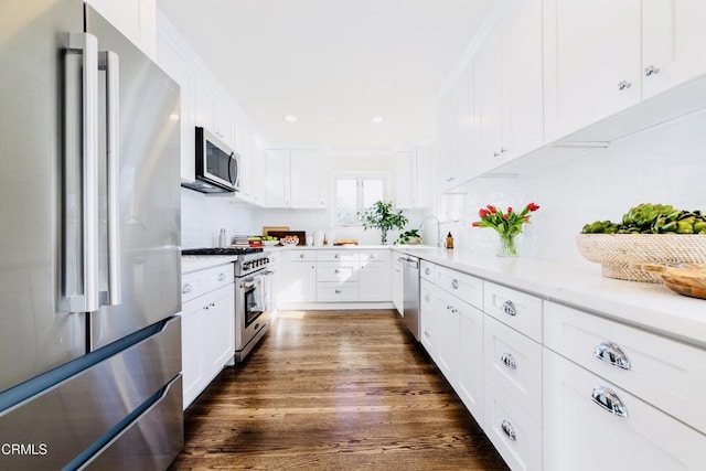 kitchen featuring high end appliances, sink, white cabinetry, and dark hardwood / wood-style floors