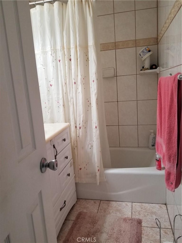 full bathroom featuring shower / bath combination with curtain, tile patterned flooring, and vanity