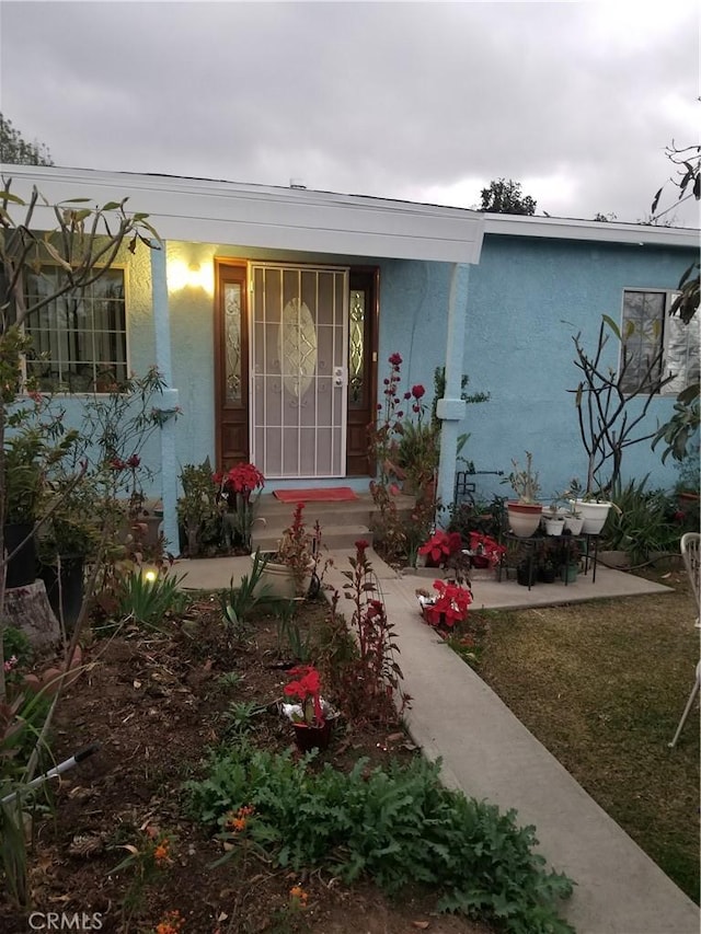 entrance to property with a lawn