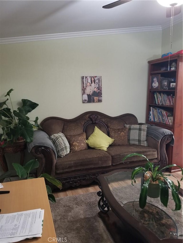 living room with ceiling fan, ornamental molding, and wood finished floors