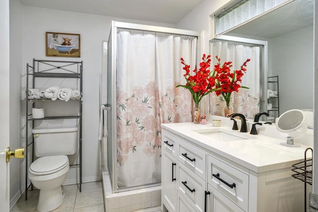 bathroom featuring a stall shower, baseboards, toilet, tile patterned floors, and vanity