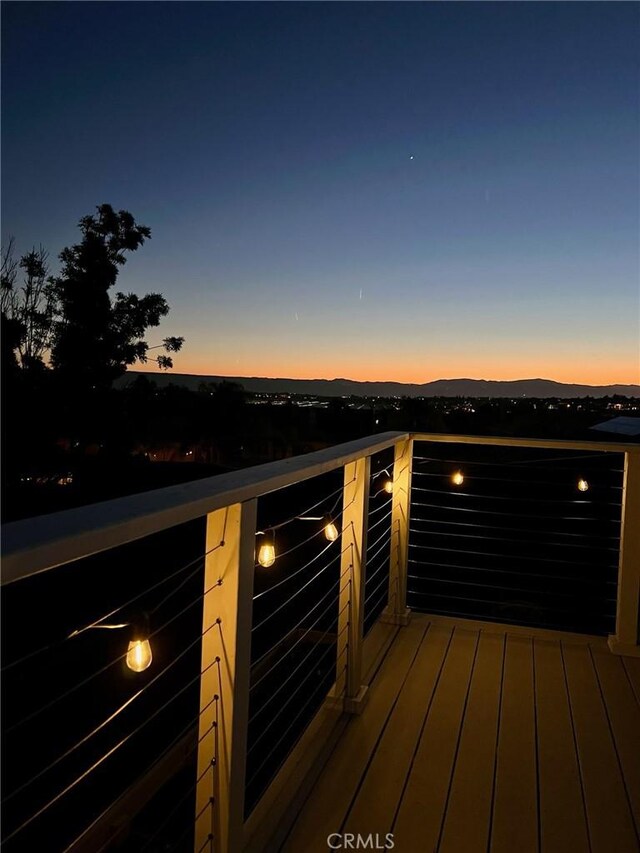 deck at dusk with a mountain view