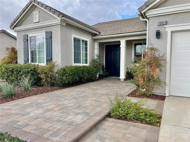 view of exterior entry with a garage