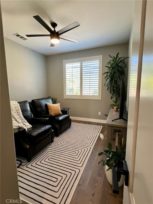 interior space featuring dark wood-type flooring and ceiling fan