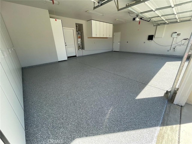 garage with a garage door opener and water heater