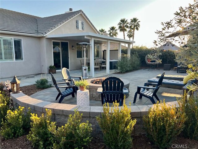 view of patio with a fire pit