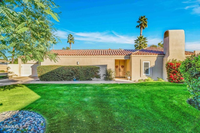 view of front of home featuring a garage and a front lawn