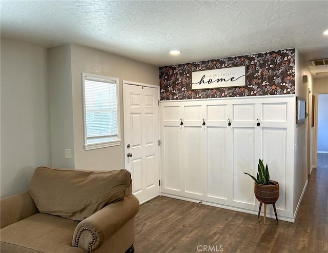 interior space with dark hardwood / wood-style floors and a textured ceiling