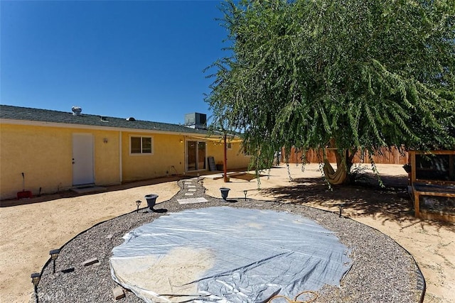 rear view of property featuring central AC unit and a patio area