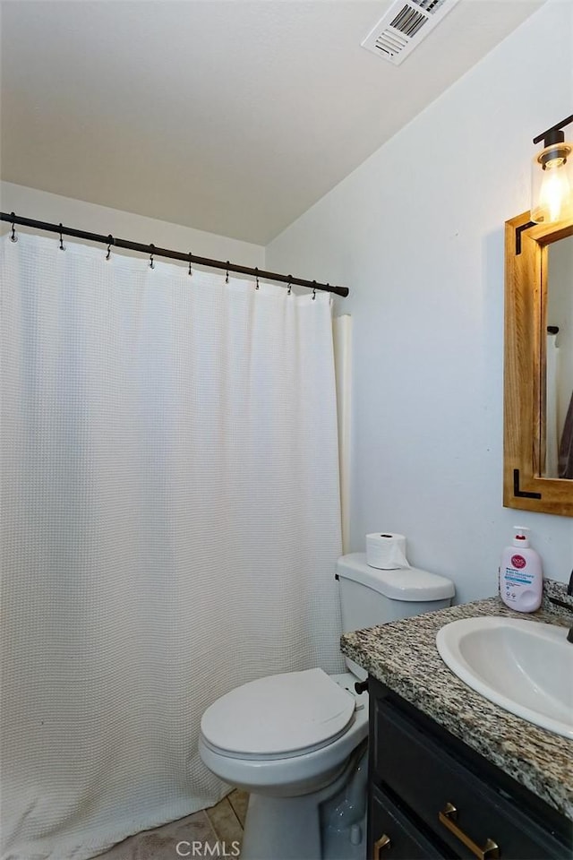 bathroom with vanity, tile patterned floors, and toilet