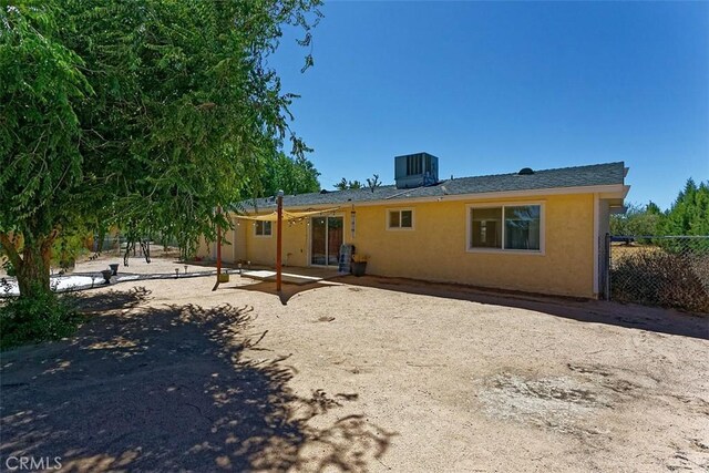 back of property with a patio, fence, cooling unit, and stucco siding