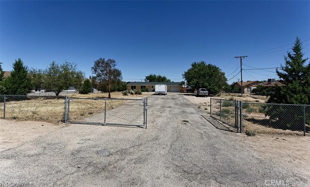 view of road featuring a gate, driveway, and a gated entry