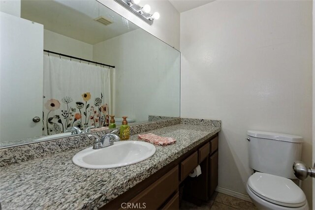 bathroom featuring toilet, tile patterned flooring, visible vents, and vanity