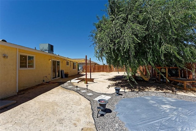 view of yard with a patio area, a fenced backyard, and cooling unit