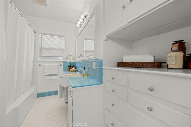 bathroom featuring vanity, tile patterned flooring, and shower / tub combo with curtain