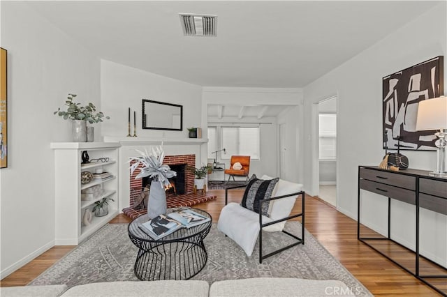 living room with wood-type flooring and a fireplace