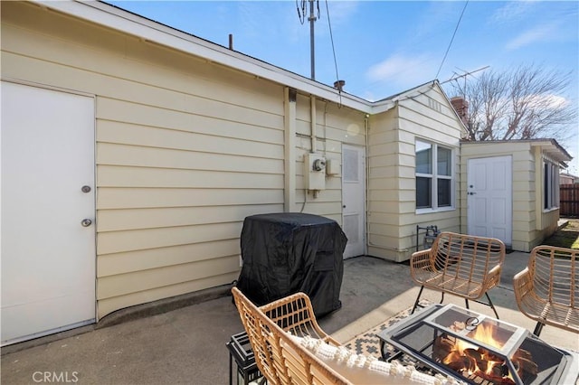 view of patio with area for grilling and an outdoor fire pit