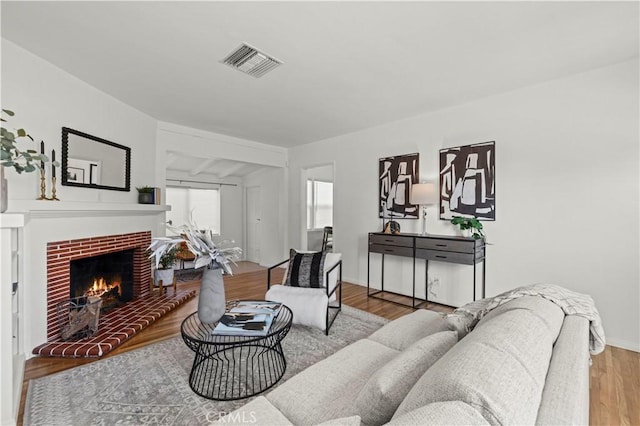 living room with hardwood / wood-style flooring and a fireplace