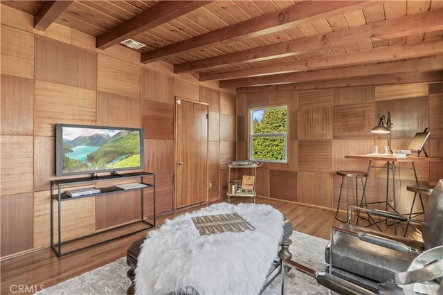 bedroom with hardwood / wood-style flooring, wood ceiling, wooden walls, and beamed ceiling