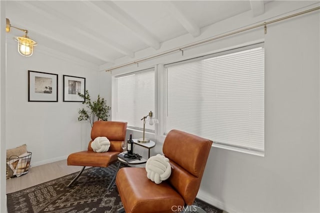 sitting room with vaulted ceiling with beams and hardwood / wood-style floors