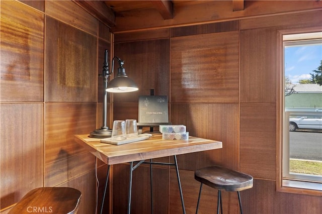 bar featuring butcher block counters and wood walls