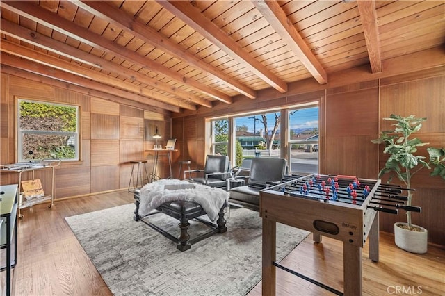 game room with hardwood / wood-style flooring, vaulted ceiling with beams, wooden ceiling, and wood walls