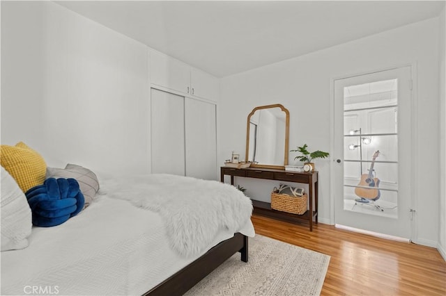 bedroom with a closet and light hardwood / wood-style flooring