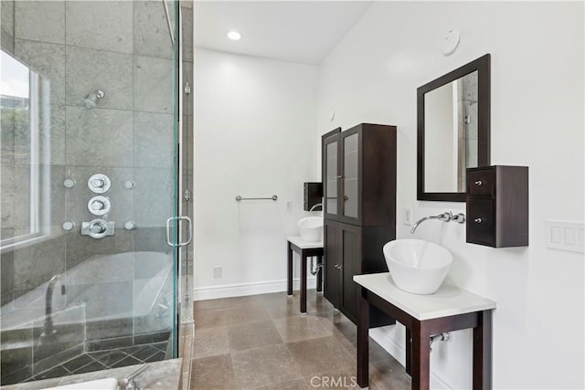 bathroom featuring an enclosed shower and sink