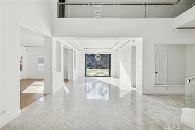 foyer entrance featuring a towering ceiling