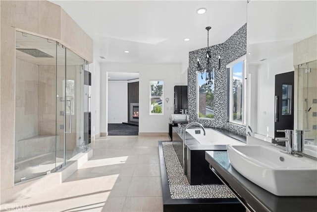 bathroom with sink, a shower with shower door, and tile patterned floors