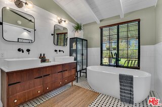 bathroom with wood-type flooring, vaulted ceiling with beams, tile walls, a tub to relax in, and vanity