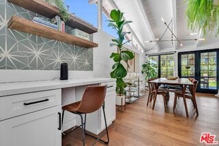 interior space with decorative backsplash, light hardwood / wood-style flooring, french doors, and white cabinets