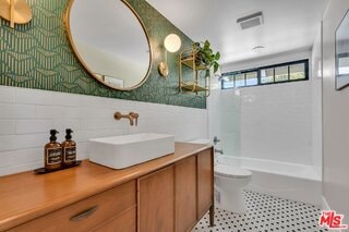 full bathroom featuring toilet, tile walls, vanity, shower / bath combination, and tile patterned flooring