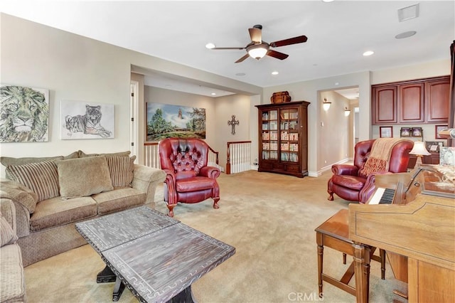 living room featuring light colored carpet and ceiling fan