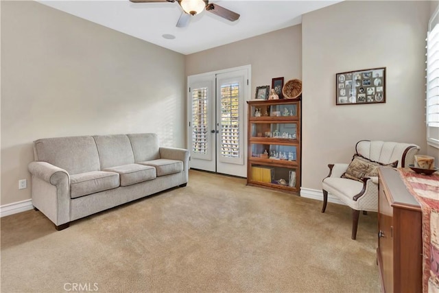 living room featuring ceiling fan and light colored carpet