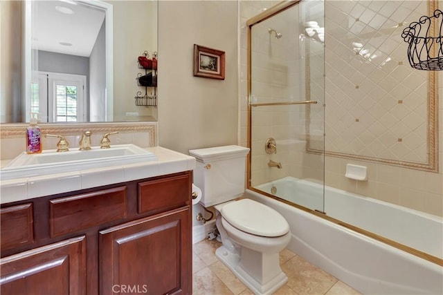 full bathroom featuring enclosed tub / shower combo, vanity, toilet, and tile patterned flooring