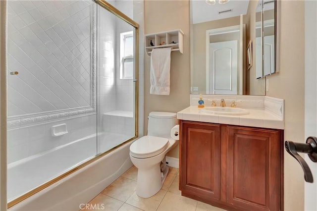 full bathroom featuring toilet, vanity, shower / bath combination with glass door, and tile patterned flooring