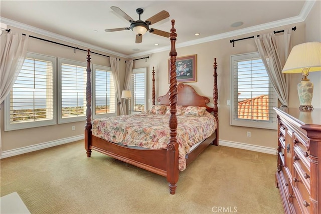 carpeted bedroom with ornamental molding and ceiling fan