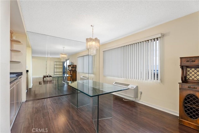 interior space with a textured ceiling, a notable chandelier, and dark hardwood / wood-style flooring